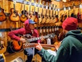 Two guitarists playing at guitar center.