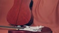 Two guitars and a microphone lie on a scarlet cloth Royalty Free Stock Photo