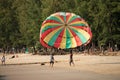 Two guys on beach keeping ready to fly in air colorful parachute. Bang Thao beach, Thailand