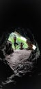 Two guys are doing yoga activities and meditation in a rock cave of wild