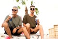 Two guys drink cocktails on a tropical beach Royalty Free Stock Photo