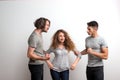 Two guys fighting over a girl, a studio shot. Royalty Free Stock Photo