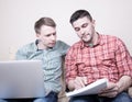 Two guys with gadgets Royalty Free Stock Photo