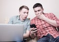 Two guys with gadgets Royalty Free Stock Photo