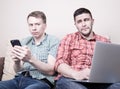 Two guys with gadgets Royalty Free Stock Photo