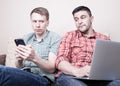 Two guys with gadgets Royalty Free Stock Photo