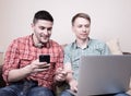 Two guys with gadgets Royalty Free Stock Photo