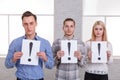 Two guys and a girl holding sheets with exclamation marks Royalty Free Stock Photo