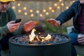 Two guys hanging out around a backyard fire pit in autumn Royalty Free Stock Photo