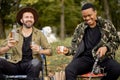 Two male friends fishing with alcoholic drinks Royalty Free Stock Photo