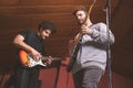 Two guys playing the electric guitar and singing Royalty Free Stock Photo