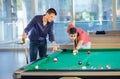 Two guys in pool billiard club playing pool billiard Royalty Free Stock Photo