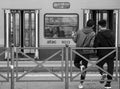 Rome, Italy. February 23, 2020. Two guys are waiting for the tram at the stop. In background, two boyfriends kiss in the carriage