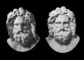 Two gypsum copy of antique statue Zeus head isolated on black background. Plaster sculpture man face with beard.