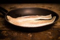 Two haddock fillets in frying pan Royalty Free Stock Photo
