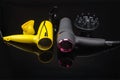 Two hair dryers on the black mirror background with accessory Royalty Free Stock Photo