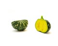 Two half cuts of baby winter squash, round eight ball gourd faint vertical ridges, speckled green striping, yellow mottling