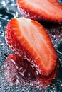 Two half fresh strawberries with water macro Royalty Free Stock Photo