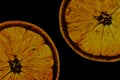 Two half juicy ripe orange on black background