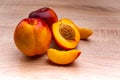 Two and half nectarine on wooden background Royalty Free Stock Photo