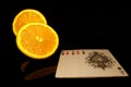 Two  half orange and an aces full houde  poker cards   isolated on black with reflections Royalty Free Stock Photo