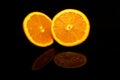 Two  half orange isolated on black with reflections Royalty Free Stock Photo