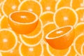 Two half oranges in front of a blurred orange slices Royalty Free Stock Photo