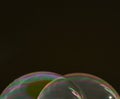 Two half soap bubbles superimposed on a black background, Horizontal format