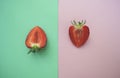 Two half of strawberry on pink and turquoise background. Royalty Free Stock Photo