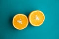 Two halfs of oranges on turquois background