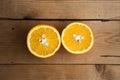 Two halfs of oranges on wooden background