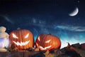 Two halloween pumpkins on fence with starry sky Royalty Free Stock Photo