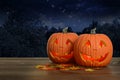 Two Halloween pumpkins at night glowing Royalty Free Stock Photo