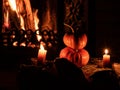 Two Halloween pumpkins in the dark on birch logs burning candles. In the background is a flame from a fireplace Royalty Free Stock Photo