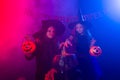 Two halloween witches making a potion and conjure in halloween night. Magic, holidays and mystic concept.