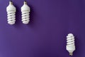 Three halogen white lamps on the top of violet background on the bottom