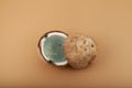Two halved Moldy spoiled coconut. Concept - Improper food storage. Reduction of organic waste. Ugly coco fruit. Brown background,