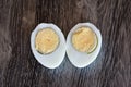 Two halves of boiled chicken egg on a cutting board Royalty Free Stock Photo