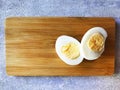 two halves of a boiled egg on a board Royalty Free Stock Photo