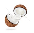 Two halves of a coconut with milk splashes isolated on a white background Royalty Free Stock Photo