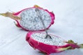 Two halves of dragon fruit with spoon on white background, tropical fruit Royalty Free Stock Photo