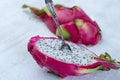 Two halves of dragon fruit with spoon on white background, tropical fruit Royalty Free Stock Photo