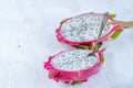 Two halves of dragon fruit with spoon on white background, tropical fruit Royalty Free Stock Photo