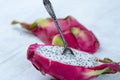 Two halves of dragon fruit with spoon on white background, tropical fruit Royalty Free Stock Photo