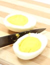 Two halves of egg with ceramic knife Royalty Free Stock Photo