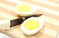 Two halves of egg with ceramic knife Royalty Free Stock Photo