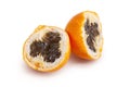 Two halves of grenadilla fruit on a white background