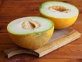 Two halves of a melon on wooden board Royalty Free Stock Photo