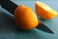 Two halves orange fruit on green board Royalty Free Stock Photo