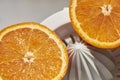 Two halves of an orange on a manual juicer on a white background Royalty Free Stock Photo